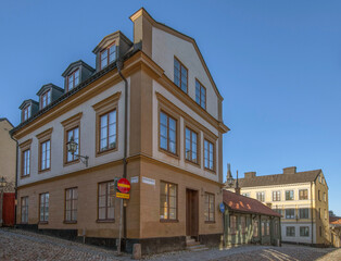 Old 1700s apartment houses with tin roofs and chimneys in the district Södermalm a winter day in Stockholm