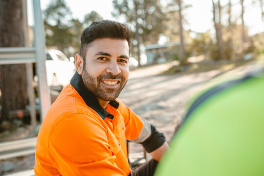 Closeup of a construction worker sitting on the ground of the construction site.