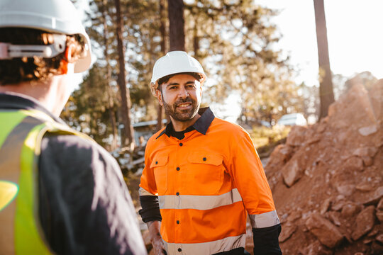 Construction workers standing at the construction site.