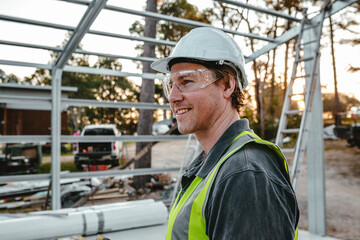 Side view of a man wearing a safety gear at the construction site.