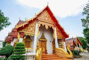 Chiang Mai, Thailand - May 23, 2019: A golden-decorated entrance of a temple.