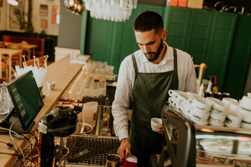 Artisan barista skillfully pours milk into a delicate cupof coffee  in a cozy cafe during a vibrant morning rush