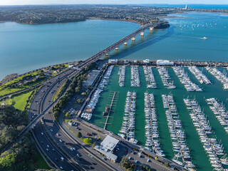 Obraz premium Aerial: Westhaven marina and auckland harbour bridge, Auckland city, New Zealand