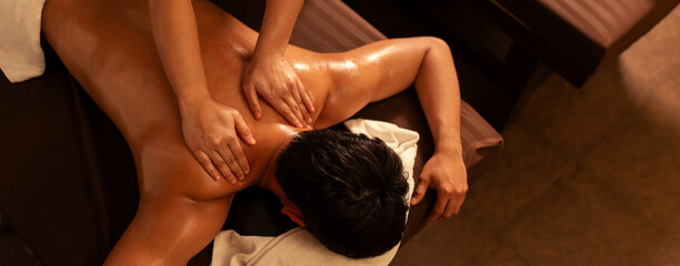 Top view, Aromatherapy massage, Masseuse hand massage aroma on back a man customer in cosmetology...