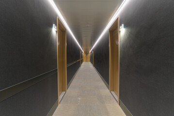 Symmetrical Hotel Corridor with Minimalist Design and Wooden Doors