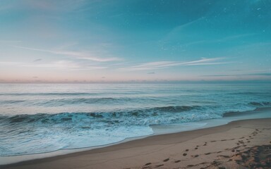 Fototapeta premium Tranquil beach sunset. Serene seascape at dusk, with gentle waves lapping on a sandy shore under a sky filled with stars.
