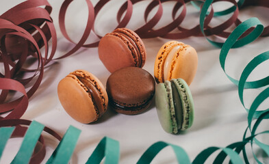 Close up of different pastel colored macaron cakes filled with cream. Culinary and cooking concept....