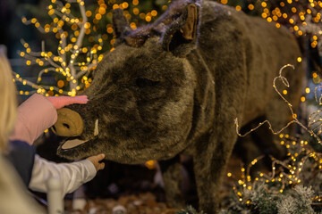 New Year's decorations, toys and garlands in fabulous settings. Toy animals for children in a public place.