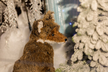 New Year's decorations, toys and garlands in fabulous settings. Toy animals for children in a public place.