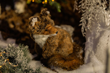 New Year's decorations, toys and garlands in fabulous settings. Toy animals for children in a public place.