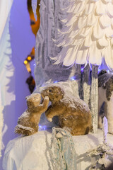 New Year's decorations, toys and garlands in fabulous settings. Toy animals for children in a public place.