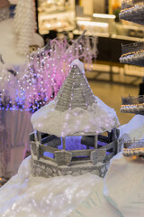 New Year's decorations, toys and garlands on the windows in fabulous scenery. Houses for children in a public place.