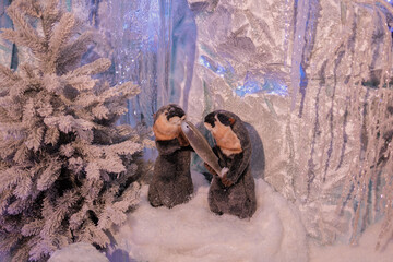 New Year's decorations, toys and garlands in fabulous settings. Toy animals for children in a public place.