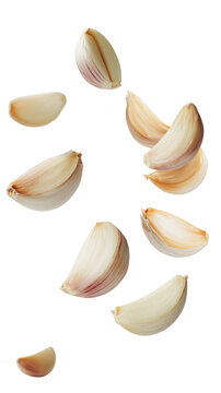 Fresh garlic cloves in mid-air on transparent background