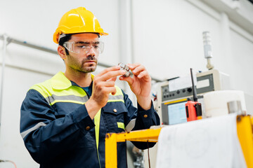 Professional Engineering of modern factory checking  to automatic machinery. Engineering with clipboard Programmable Logic Controller to manage large machine working full automatic.