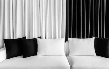 Side perspective of the sofa, capturing how the white and black curtains frame the white sofa. 