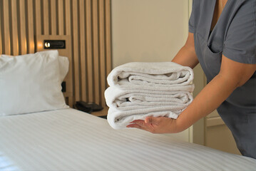  Hotel Staff Arranging Fresh Towels on Bed in Clean and Comfortable Room