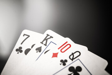 High-Stakes Poker Hand: Seven, King, Ten, and Queen of Spades in a Competitive Gaming Environment