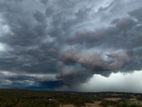 Aerial view of rain falling from a dark dramatic storm front