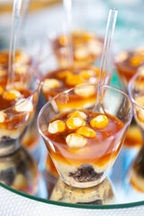 Delicious Layered Dessert Cups With Caramel and Almonds Served at a Festive Event
