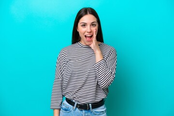 Young caucasian woman isolated on blue background with surprise and shocked facial expression