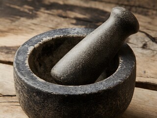 A photo of a mortar. There is a pestle in the mortar. 
