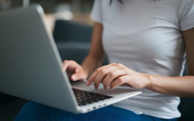 Fototapeta premium A photo of a Woman Using Silver Laptop