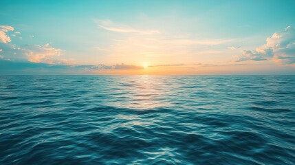 Obraz premium The sun sets gently over the still ocean, painting the horizon in soft colors