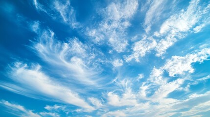 Fototapeta premium A Vibrant Blue Sky Adorned with Wispy White Clouds