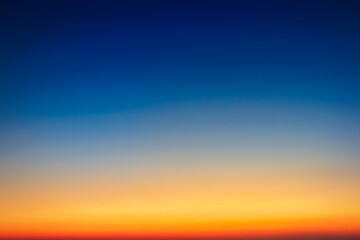 The sky gradient from deep blue to orange sunset.