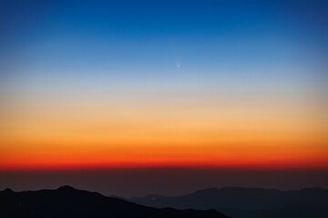 Comet C/2023 A3 Tsuchinsan ATLAS is traveling through space. The comet appears in the early evening after sunset or in the early morning before sunrise.