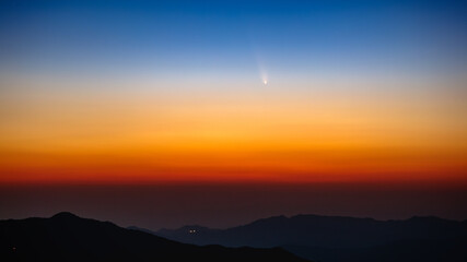 Comet C/2023 A3 Tsuchinsan ATLAS is traveling through space. The comet appears in the early evening...
