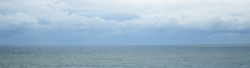 Cloudy sky over the blue sea