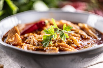 Tasty soup or stew made of beef tripe and spices. Spicy and aromatic tripe soup seasoned with pepper and served with bread