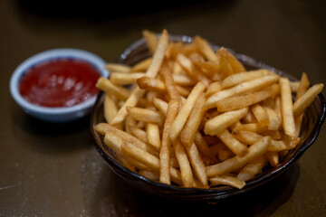 french fries on plate with tomato sauce