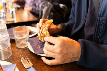 Close up of Hands Eating Pastry at a Cafe