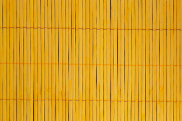 close up of yellow mat made of bamboo sticks