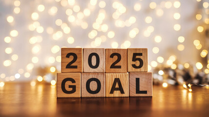 Wooden blocks display 2025 goal with festive lights in the background.