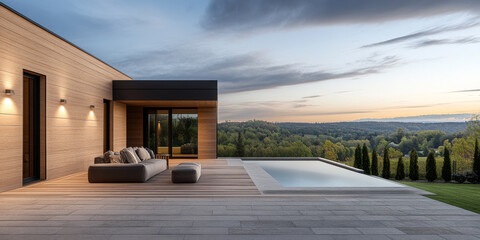 Modern outdoor living space with pool and scenic view during sunset