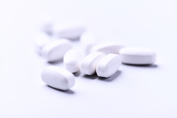 Amino acids tablets. Nutrition for bodybuilding. Fitness supplements on bright background. Soft focus. Copy space.
