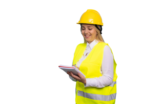 Energetic young woman engineer in a hard hat on-site