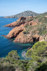Views along Corniche d’Or or Corniche de l’Esterel beautiful coastal road, crystalline blue sea and sky combined with reddish color of Massif de l’Esterel mountains, travel destination in France