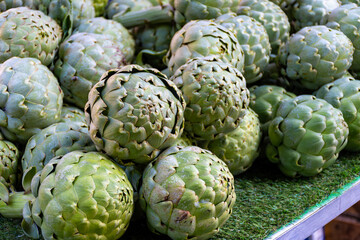 Fresh ripe green organic artichokes heads on local farmers market in Dordogne, France