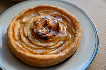 French fresh baked sweet puff pastry with fresh apple fruits in sirup  in confectionery shop