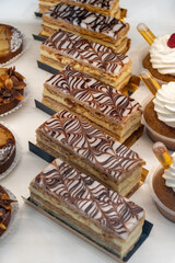 Portion of french mille-feuille cake, vanilla or custard slice, Napoleon puff pastry layered with pastry cream in bakery