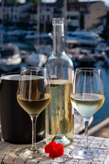 Glasses of cold white Cote de Provence wine in yacht harbour of Port Grimaud, summer vacation on French Riviera in Provence, France, wine tasting