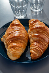 Fresh baked buttered croissants served in restaurant for continental or French breakfast close up
