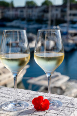 Glasses of cold white Cote de Provence wine in yacht harbour of Port Grimaud, summer vacation on French Riviera in Provence, France, wine tasting