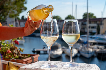Glasses of cold rose gris Cote de Provence wine in yacht harbour of Port Grimaud, summer vacation on French Riviera in Provence, France, wine tasting