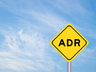 Naklejka premium Yellow transportation sign with word ADR (Abbreviation of adverse drug reaction) on blue color sky background